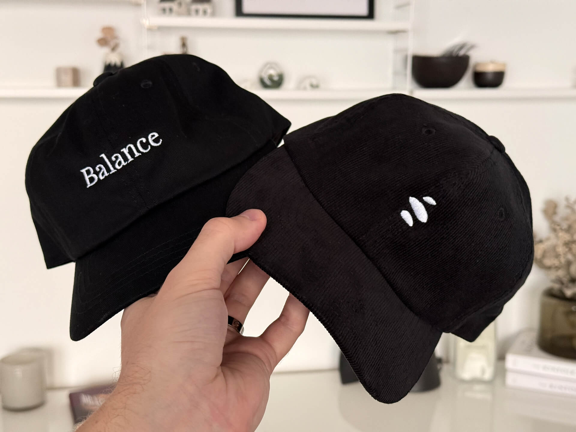 Two black caps, one with the text